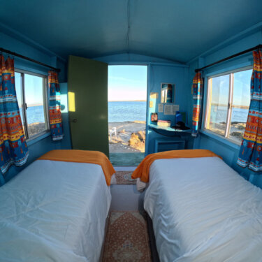 Two single beds with a beach view