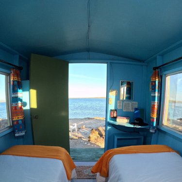Two single beds with a beach view
